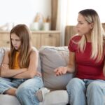 Woman mother scolding her stubborn daughter at home